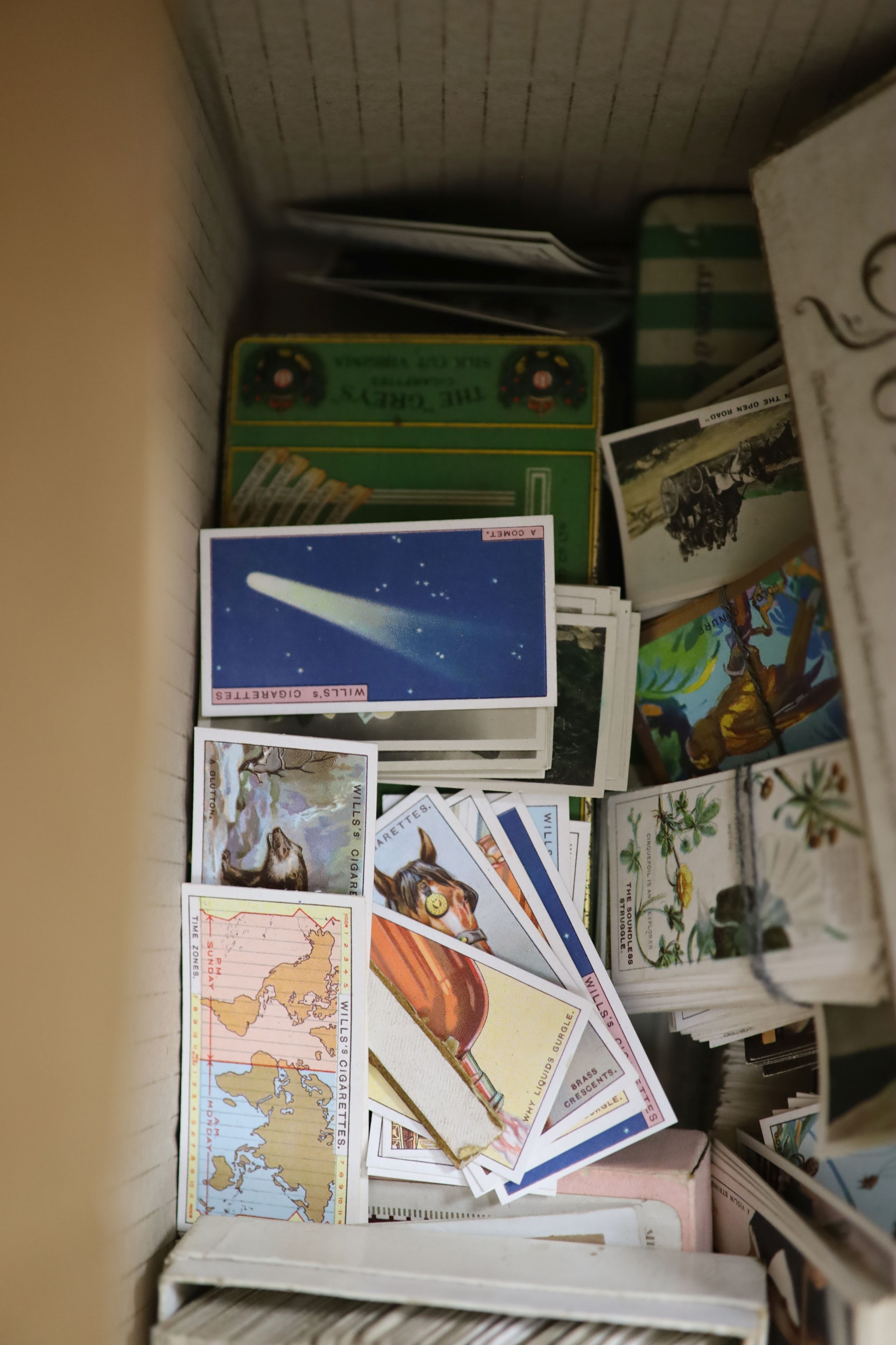 A collection of cigarette cards and ephemera